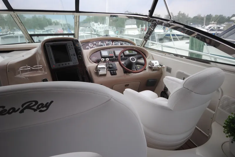  Yacht Photos Pics 2002 Sea Ray 380 Sundancer helm with white seating and modern controls.