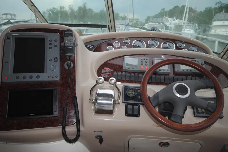  Yacht Photos Pics Helm of 2002 Sea Ray 380 Sundancer with navigation equipment and steering wheel.