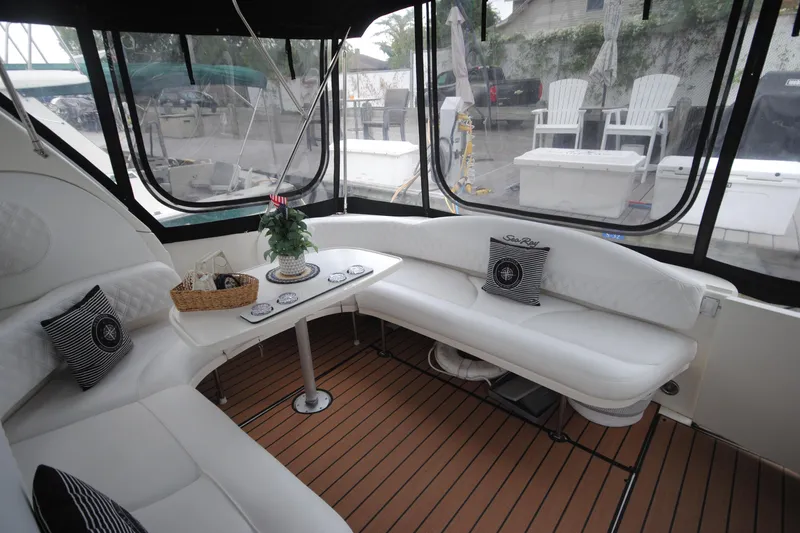  Yacht Photos Pics Luxurious interior of 2002 Sea Ray 380 Sundancer with white seating and wooden flooring.