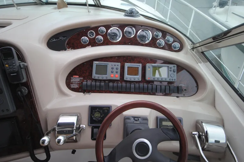  Yacht Photos Pics Cockpit of 2002 Sea Ray 380 Sundancer with navigation instruments and steering wheel.
