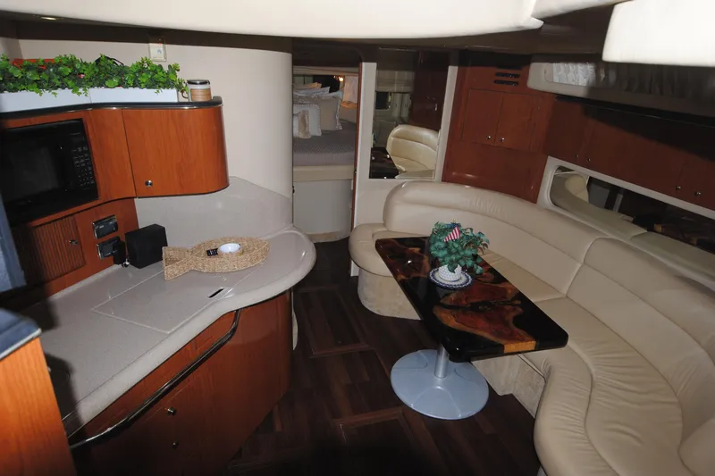  Yacht Photos Pics Luxurious interior of 2002 Sea Ray 380 Sundancer yacht with kitchen and seating area.
