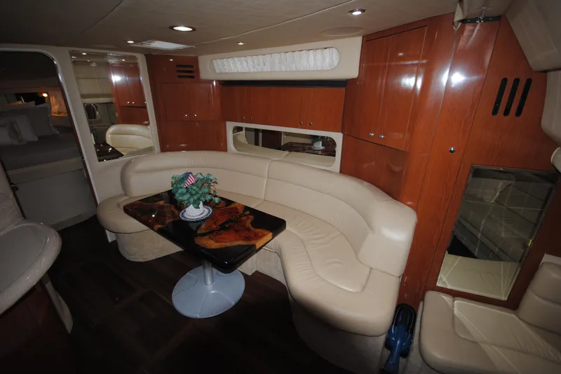  Yacht Photos Pics Luxurious interior of 2002 Sea Ray 380 Sundancer yacht with leather seating and wooden cabinetry.