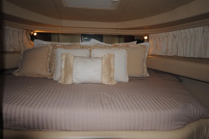  Yacht Photos Pics Luxurious cabin interior of 2002 Sea Ray 380 Sundancer with plush bedding and ambient lighting.
