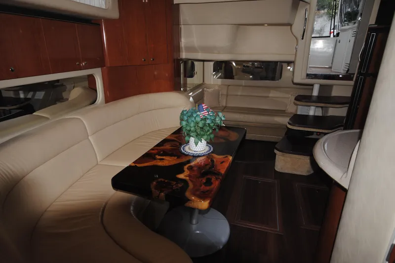  Yacht Photos Pics Luxurious interior of 2002 Sea Ray 380 Sundancer yacht with elegant seating and wooden table.