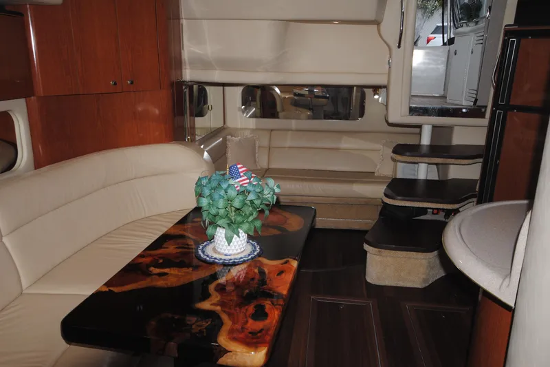  Yacht Photos Pics Luxurious interior of 2002 Sea Ray 380 Sundancer yacht with elegant seating and wooden table.