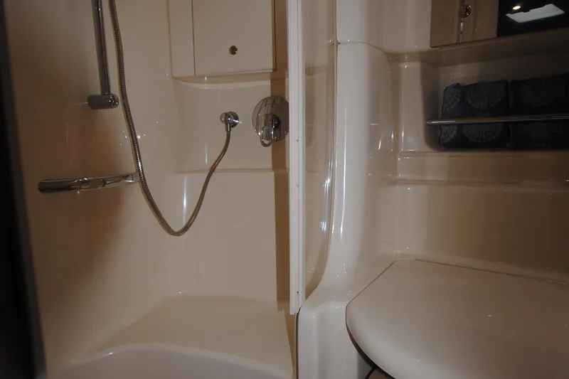  Yacht Photos Pics 2002 Sea Ray 380 Sundancer bathroom with shower and storage shelves.
