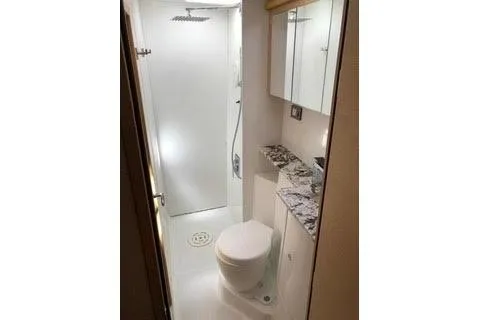  Yacht Photos Pics 2008 Lagoon 420 yacht bathroom with shower, toilet, and mirrored cabinet.