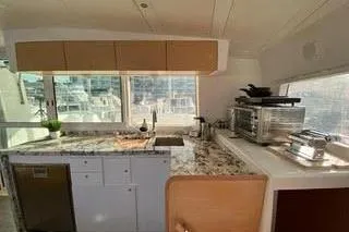  Yacht Photos Pics Interior of 2008 Lagoon 420 yacht kitchen with modern appliances and granite countertops.