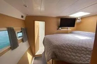  Yacht Photos Pics 2008 Lagoon 420 yacht interior with cozy bedroom, TV, and natural light.