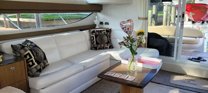 Panache Yacht Photos Pics Luxurious interior of 2016 Meridian 391 Sedan yacht with white sofa and floral decor.