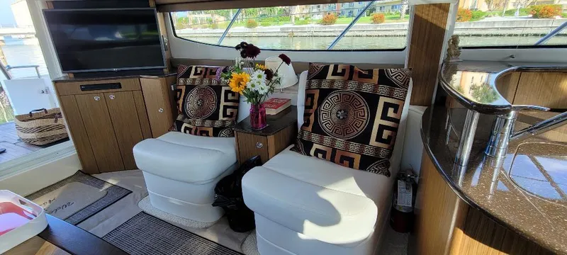 Panache Yacht Photos Pics Interior of 2016 Meridian 391 Sedan with cozy seating and decorative pillows.