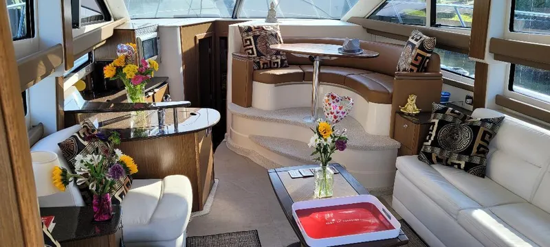 Panache Yacht Photos Pics Luxurious interior of a 2016 Meridian 391 Sedan yacht with elegant seating and floral decor.