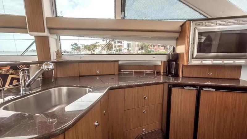 Panache Yacht Photos Pics 2016 Meridian 391 Sedan kitchen with modern appliances and sleek countertops.