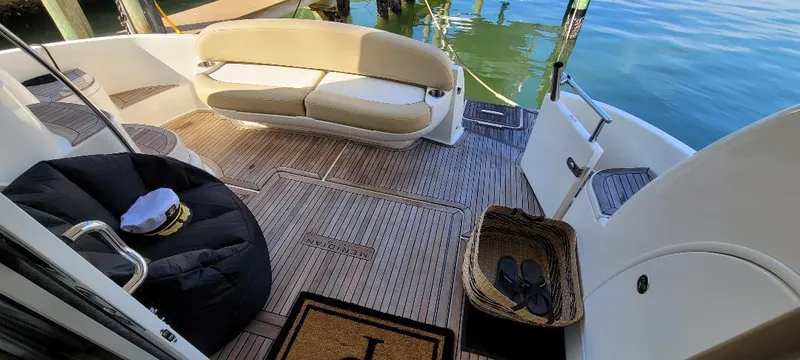 Panache Yacht Photos Pics 2016 Meridian 391 Sedan yacht deck with seating, wicker basket, and nautical decor.