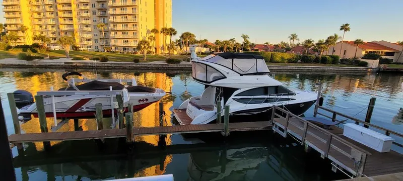 Panache Yacht Photos Pics 2016 Meridian 391 Sedan docked in a scenic marina with waterfront buildings.