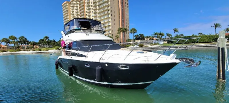 Panache Yacht Photos Pics 2016 Meridian 391 Sedan yacht docked near a waterfront building.