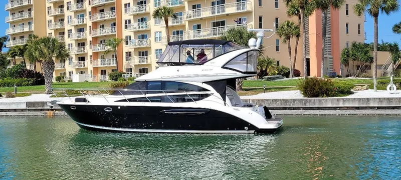 Panache Yacht Photos Pics 2016 Meridian 391 Sedan yacht cruising near waterfront apartments.