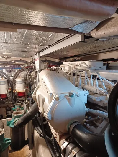 Panache Yacht Photos Pics Engine room of a 2016 Meridian 391 Sedan yacht, showcasing mechanical components and piping.