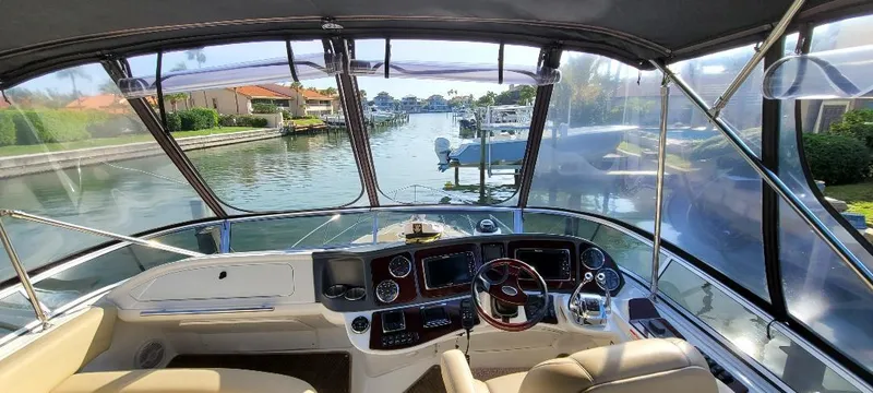 Panache Yacht Photos Pics 2016 Meridian 391 Sedan yacht cockpit with waterfront view, featuring modern navigation controls.