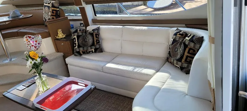Panache Yacht Photos Pics Luxurious interior of 2016 Meridian 391 Sedan with white leather seating and decorative pillows.