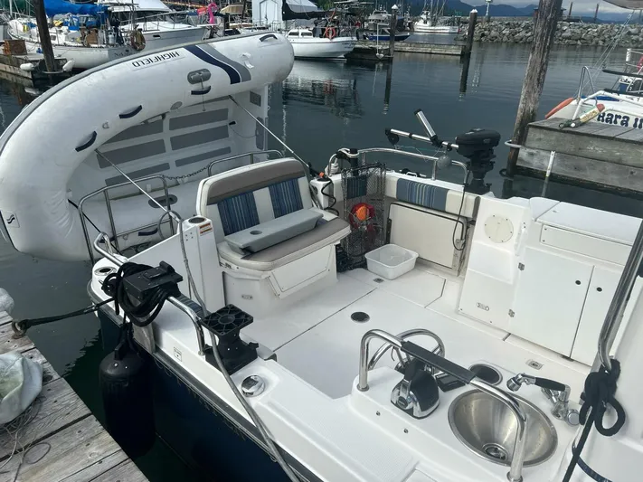  Yacht Photos Pics 2019 Cutwater C-28 boat with inflatable dinghy, docked at marina.