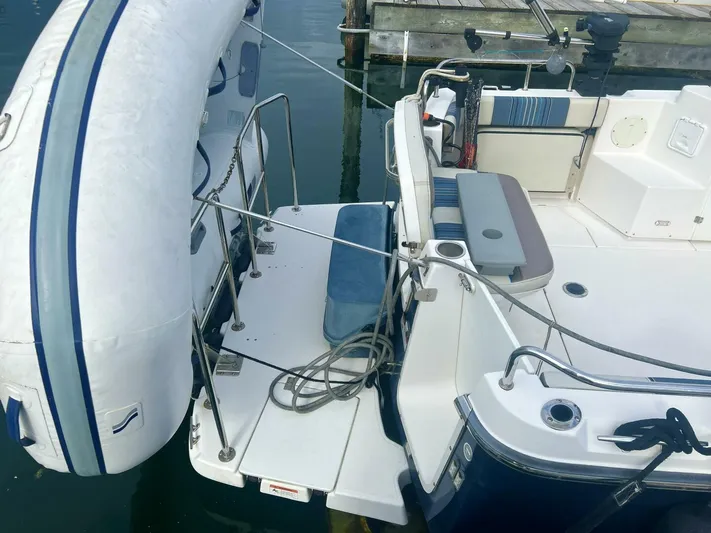  Yacht Photos Pics 2019 Cutwater C-28 boat with inflatable dinghy, docked at marina.