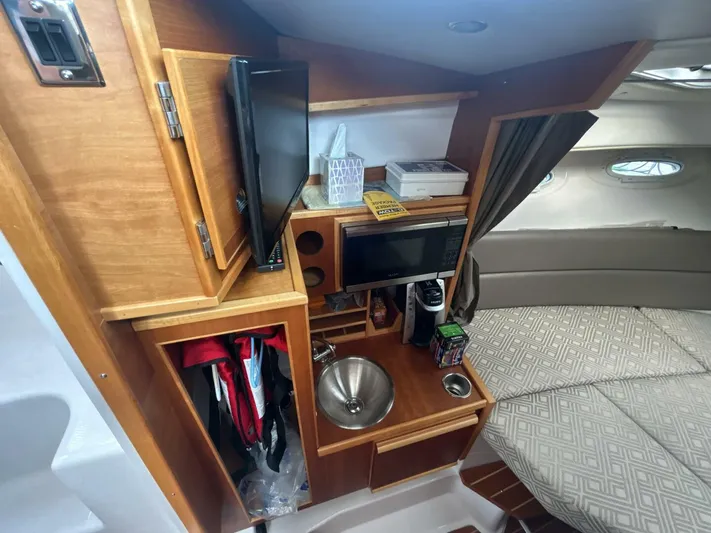  Yacht Photos Pics 2019 Cutwater C-28 cabin interior with kitchenette, sink, and bed.