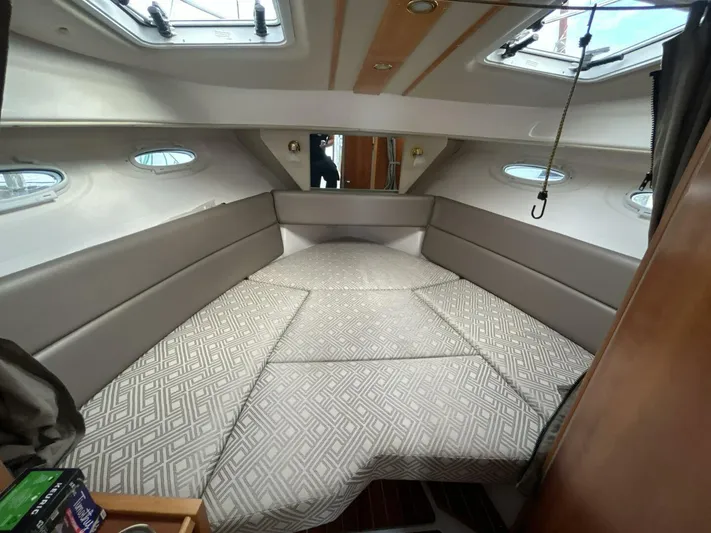  Yacht Photos Pics 2019 Cutwater C-28 cabin interior with cushioned seating and overhead windows.