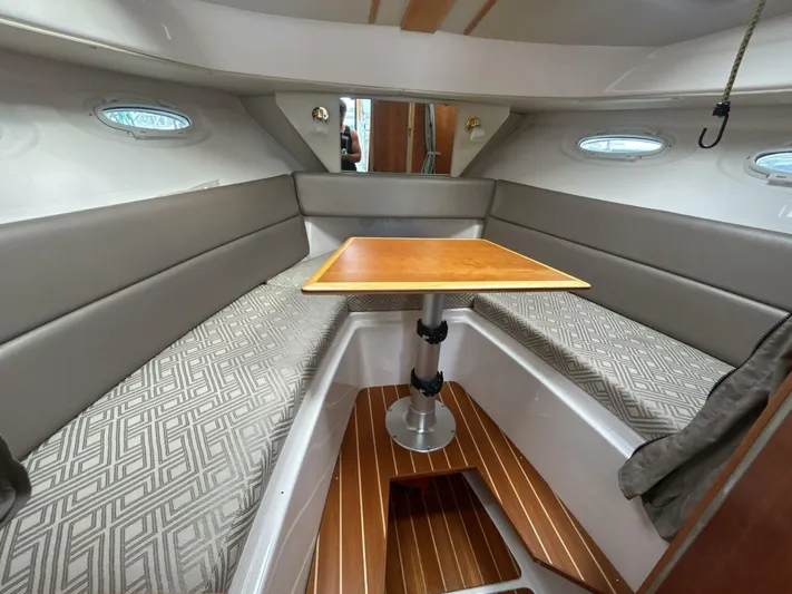  Yacht Photos Pics 2019 Cutwater C-28 cabin interior with seating, table, and wood flooring.