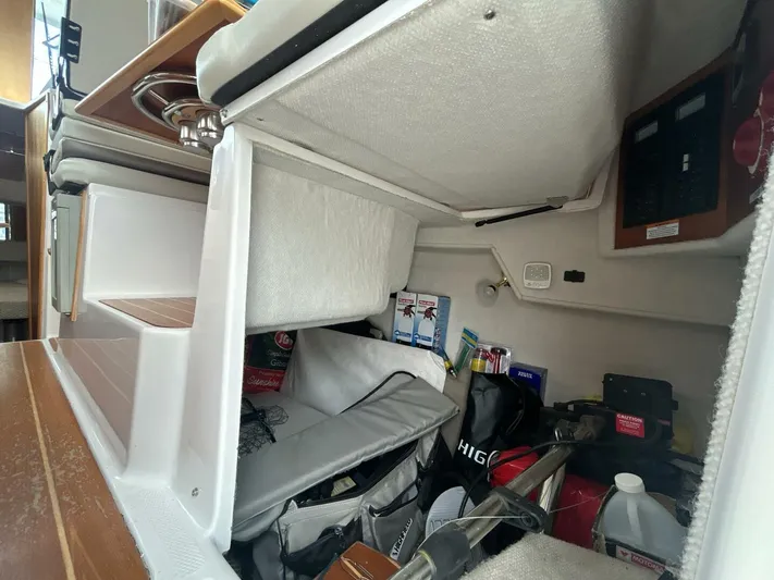  Yacht Photos Pics Interior storage area of a 2019 Cutwater C-28 boat with various supplies.