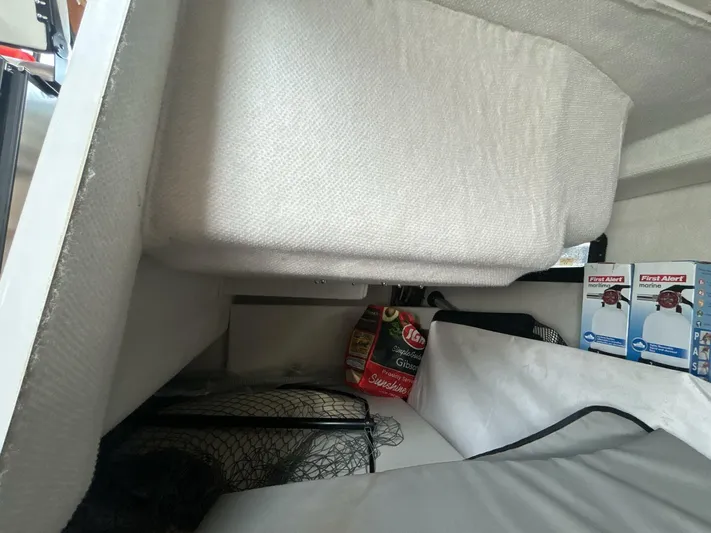  Yacht Photos Pics Interior storage area of a 2019 Cutwater C-28 boat with safety equipment and supplies.