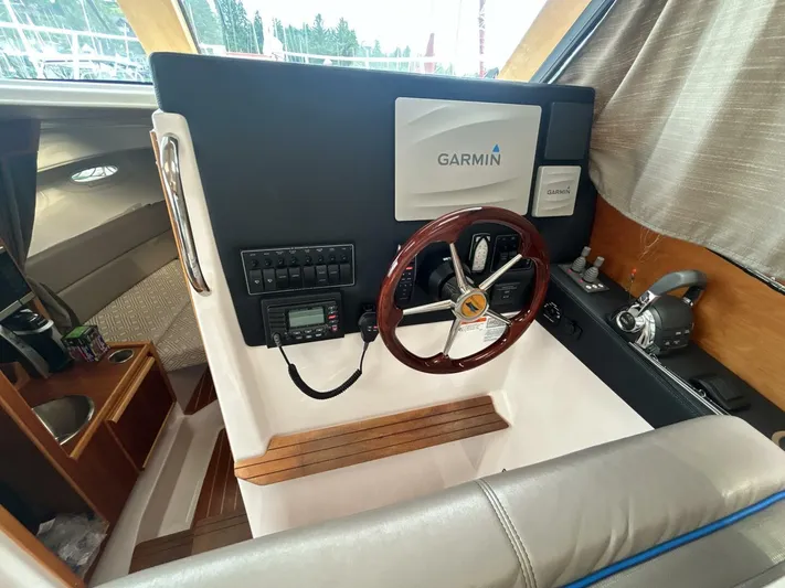  Yacht Photos Pics 2019 Cutwater C-28 helm with Garmin navigation, wood accents, and modern controls.