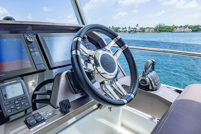 Yacht Photos Pics Cockpit of 2019 Galeon 640 Fly yacht with steering wheel and navigation screens.