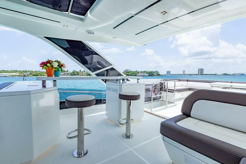  Yacht Photos Pics Luxurious 2019 Galeon 640 Fly yacht deck with seating, bar stools, and ocean view.