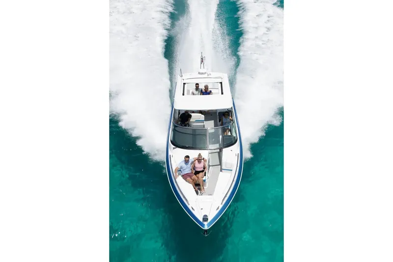 Oceanholic Yacht Photos Pics 2018 Formula 330 Crossover Bowrider cruising on clear turquoise water.