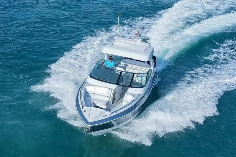 Oceanholic Yacht Photos Pics 2018 Formula 330 Crossover Bowrider cruising on clear blue water.