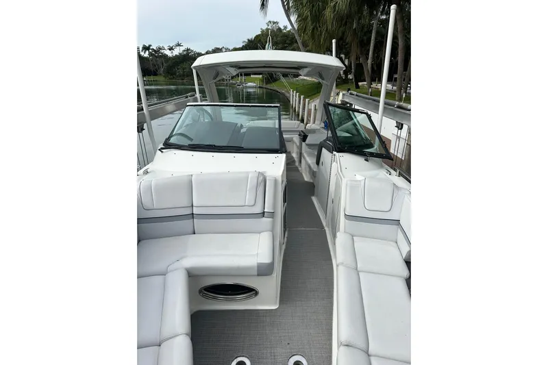 Oceanholic Yacht Photos Pics 2018 Formula 330 Crossover Bowrider with spacious seating and sleek design on a calm waterway.