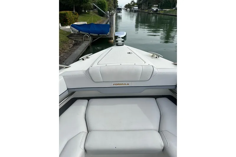 Oceanholic Yacht Photos Pics 2018 Formula 330 Crossover Bowrider on a calm canal, showcasing sleek design and comfort.