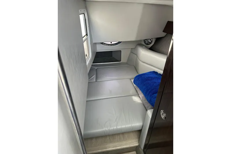 Oceanholic Yacht Photos Pics 2018 Formula 330 Crossover Bowrider cabin interior with gray seating and blue blanket.