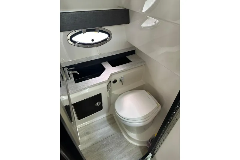 Oceanholic Yacht Photos Pics 2018 Formula 330 Crossover Bowrider bathroom with modern fixtures and porthole window.