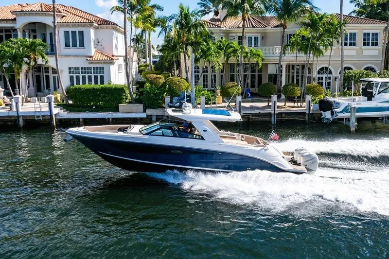 Sobe III Yacht Photos Pics 2019 Sea Ray SLX 400 Outboard cruising near luxury waterfront homes.