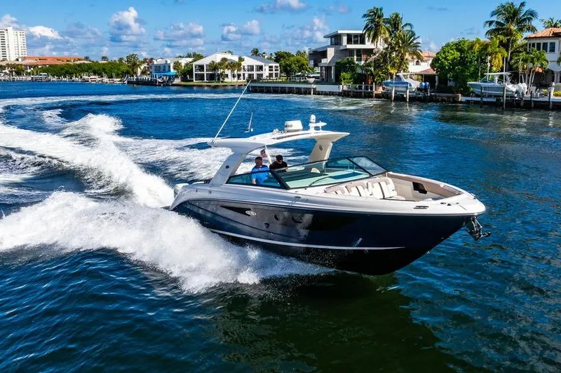 Sobe III Yacht Photos Pics 2019 Sea Ray SLX 400 Outboard cruising on a sunny waterfront with luxury homes.