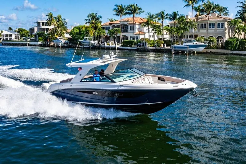 Sobe III Yacht Photos Pics 2019 Sea Ray SLX 400 Outboard cruising near luxury waterfront homes.