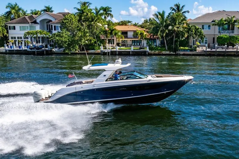 Sobe III Yacht Photos Pics 2019 Sea Ray SLX 400 Outboard cruising on a sunny waterfront near luxury homes.