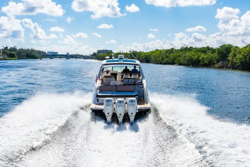 Sobe III Yacht Photos Pics 2019 Sea Ray SLX 400 Outboard cruising on a sunny day, creating a wake in the water.
