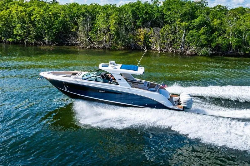 Sobe III Yacht Photos Pics 2019 Sea Ray SLX 400 Outboard cruising on a scenic waterway with lush greenery.