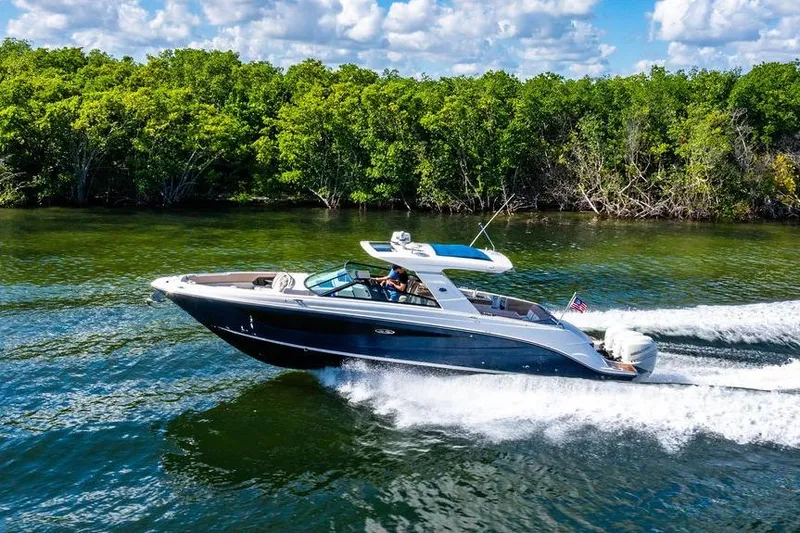 Sobe III Yacht Photos Pics 2019 Sea Ray SLX 400 Outboard cruising on a scenic waterway with lush greenery.