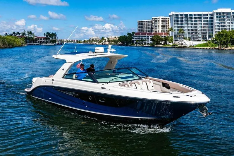 Sobe III Yacht Photos Pics 2019 Sea Ray SLX 400 Outboard cruising on a sunny day near waterfront buildings.