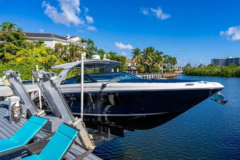 Sobe III Yacht Photos Pics 2019 Sea Ray SLX 400 Outboard docked by tropical waterfront with blue sky.