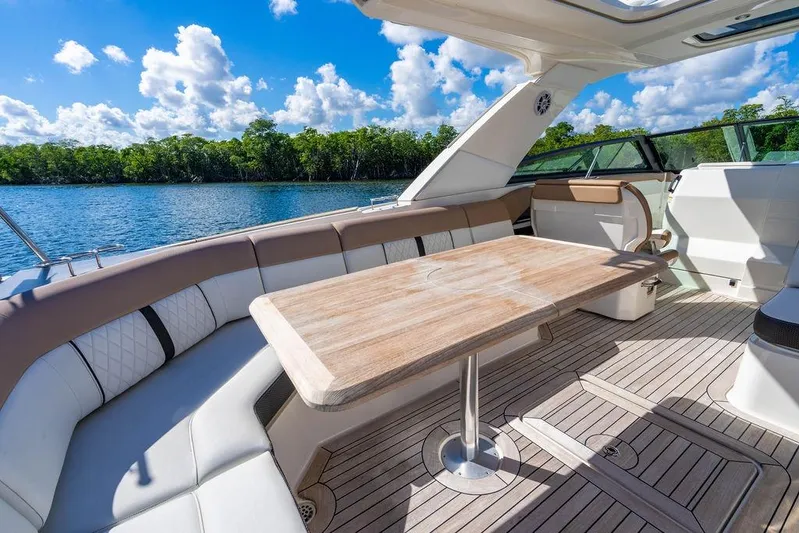 Sobe III Yacht Photos Pics Luxurious 2019 Sea Ray SLX 400 Outboard boat interior with elegant seating and wooden table.